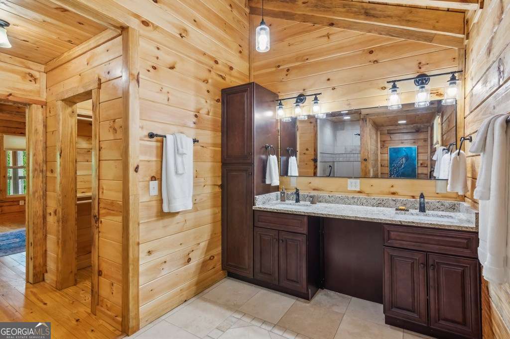 245 Timberwalk Drive, Unit 16 Ellijay, GA 30540 - Photo 25 of 56 a bathroom with a double vanity sink and a mirror