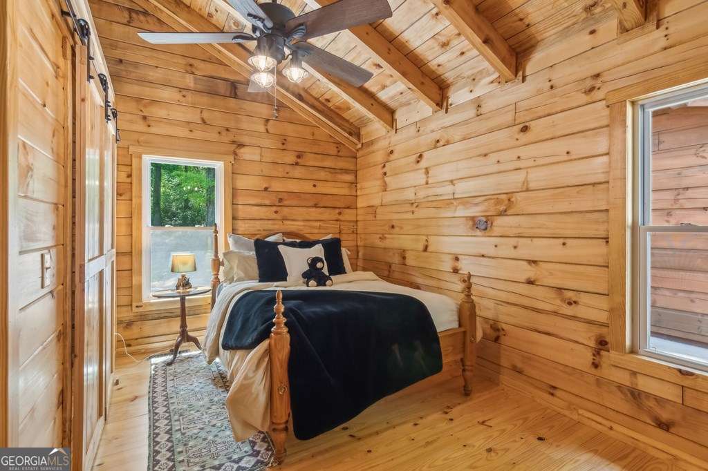 245 Timberwalk Drive, Unit 16 Ellijay, GA 30540 - Photo 28 of 56 a bedroom with a bed and a window