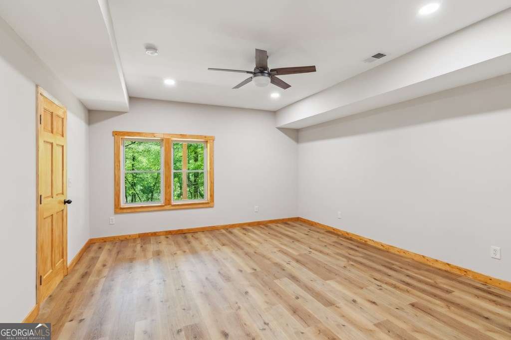 245 Timberwalk Drive, Unit 16 Ellijay, GA 30540 - Photo 33 of 56 wooden floor in an empty room with a window