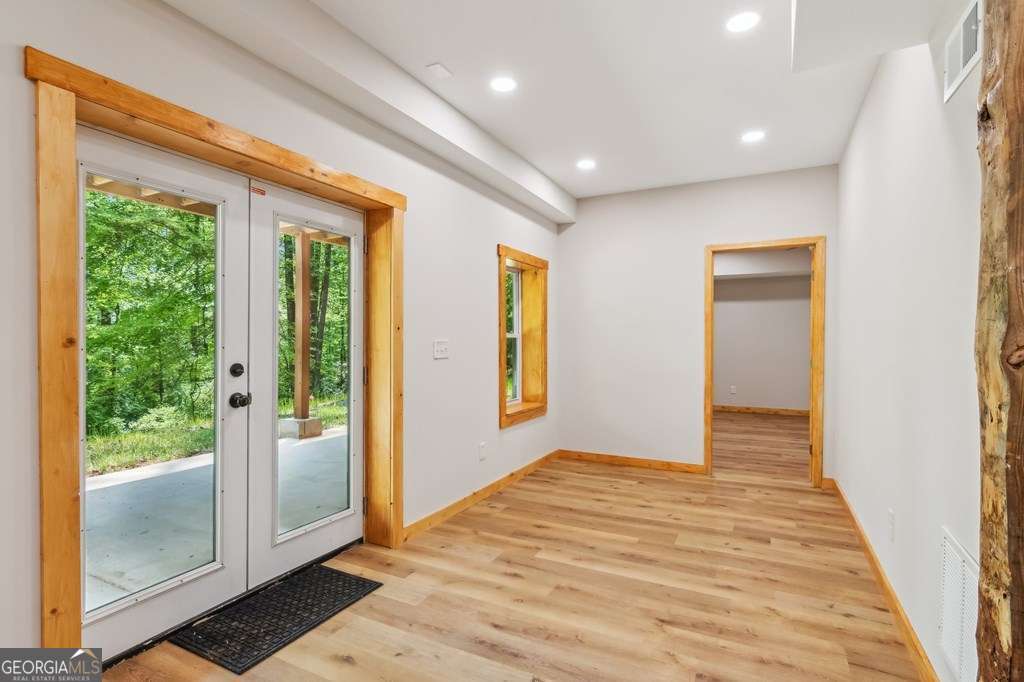 245 Timberwalk Drive, Unit 16 Ellijay, GA 30540 - Photo 34 of 56 a view of a hallway with wooden floor and windows