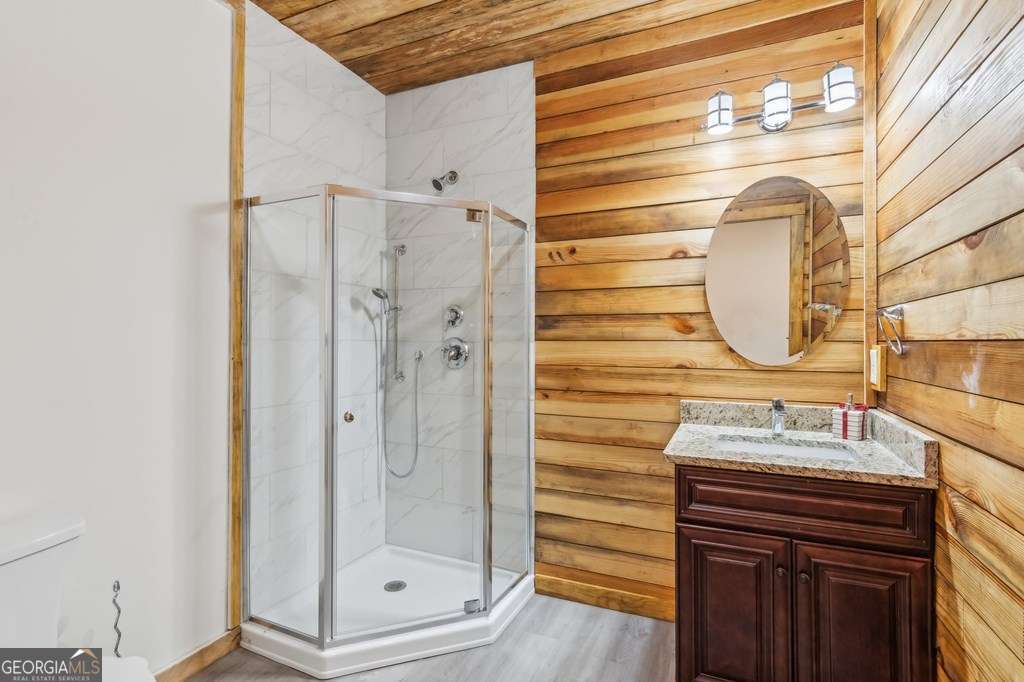 245 Timberwalk Drive, Unit 16 Ellijay, GA 30540 - Photo 38 of 56 a bathroom with a sink a mirror and a shower