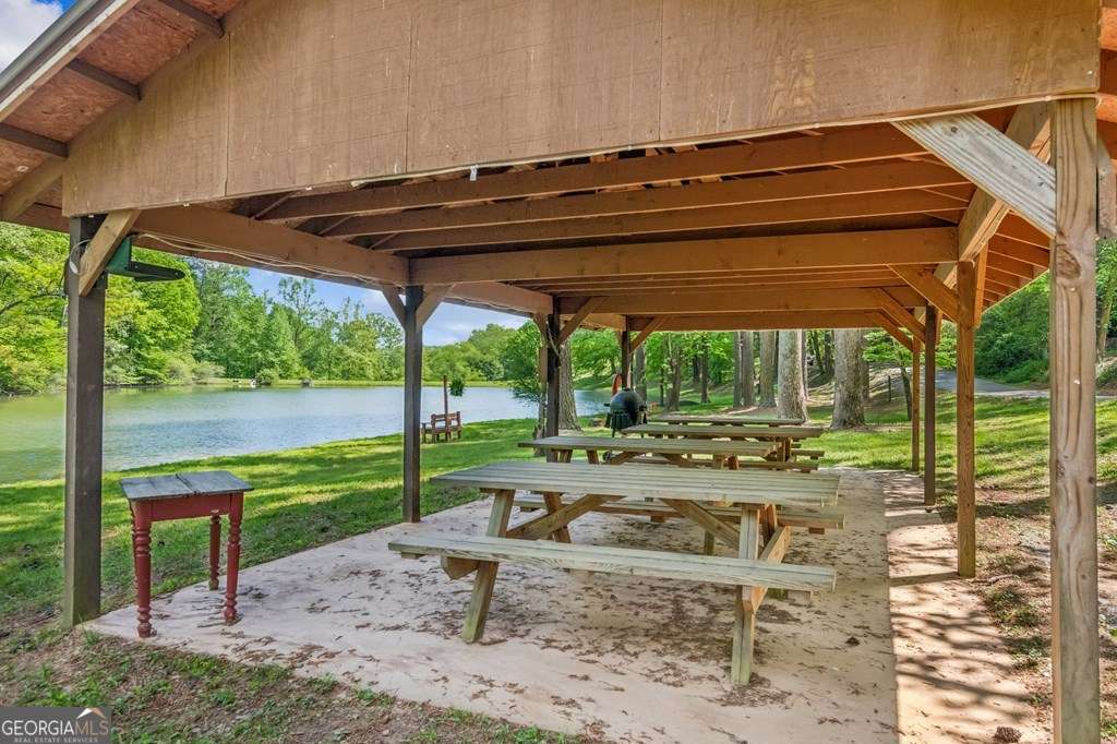 245 Timberwalk Drive, Unit 16 Ellijay, GA 30540 - Photo 45 of 56 a view of a backyard with table and chairs under an umbrella with a small yard