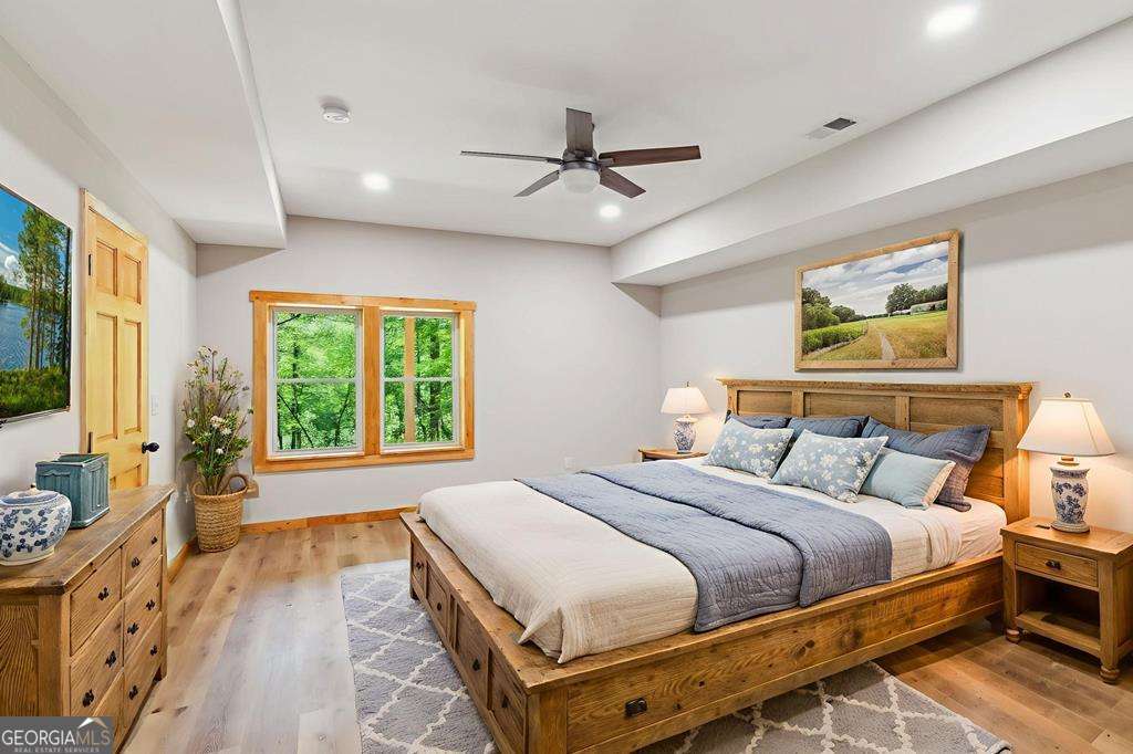 245 Timberwalk Drive, Unit 16 Ellijay, GA 30540 - Photo 54 of 56 a bedroom with a bed and a large window