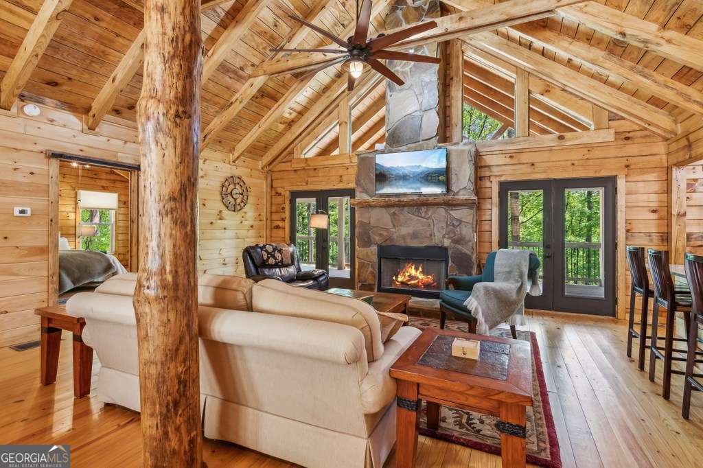 245 Timberwalk Drive, Unit 16 Ellijay, GA 30540 - Photo 10 of 56 a living room with furniture a fireplace a rug and wooden floor