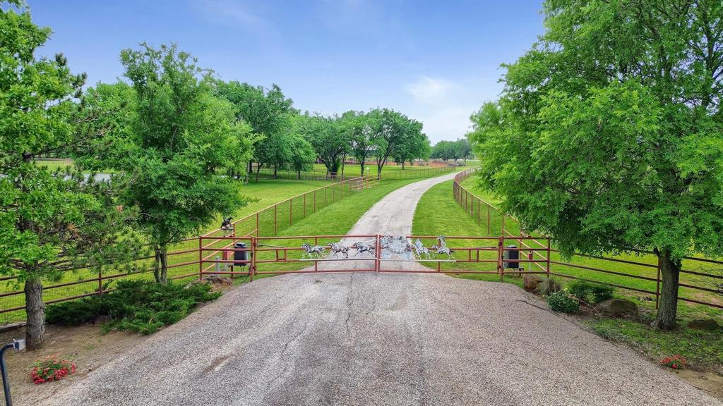 10898 Friendship Road Pilot Point, TX 76258 - Photo 3 of 24 View of asphalt road featuring a gate and a view of rural / pastoral area