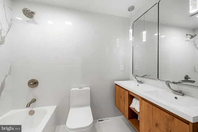 a spacious bedroom with a bed and a couch