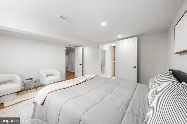 a view of bathroom with a refrigerator a sink and a mirror