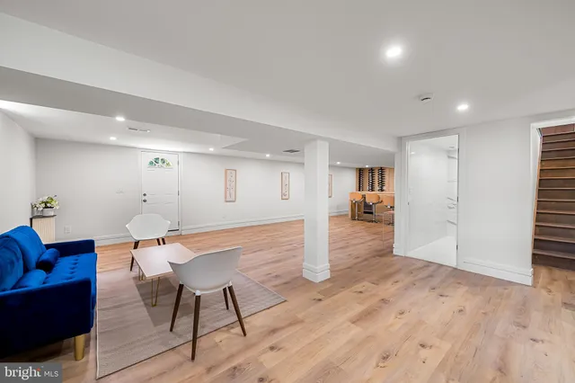 a kitchen with stainless steel appliances a dining table chairs and a refrigerator