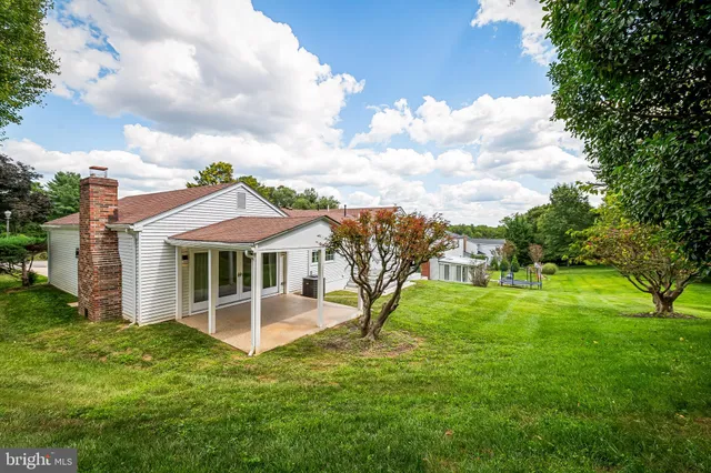 a view of a house with a backyard