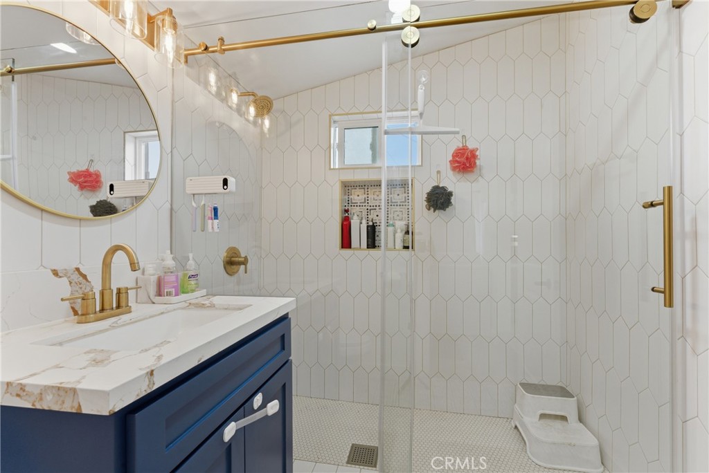 14335 Leffingwell Road Whittier, CA 90604 - Photo 24 of 42 a bathroom with a granite countertop sink a shower and a mirror