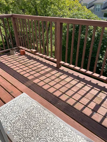 a view of a roof deck with wooden fence and wooden floor