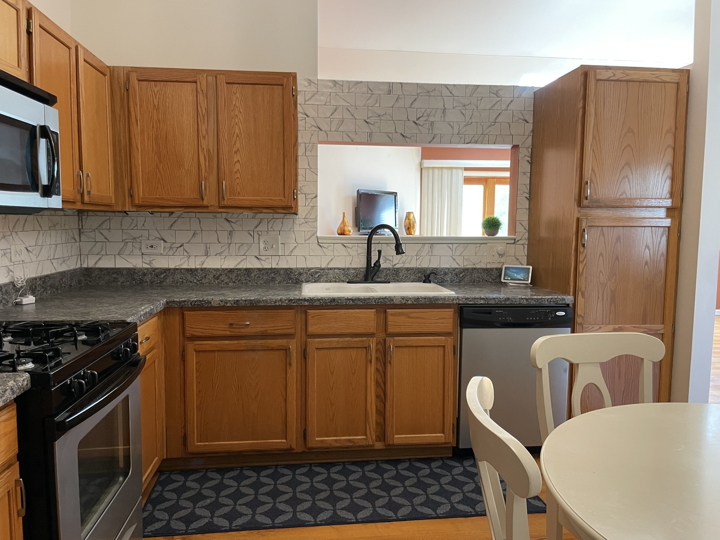 2043 Peach Tree Lane Algonquin, IL 60102 - Photo 7 of 19 a kitchen with stainless steel appliances granite countertop a sink stove refrigerator granite counter tops wooden cabinets and a couch