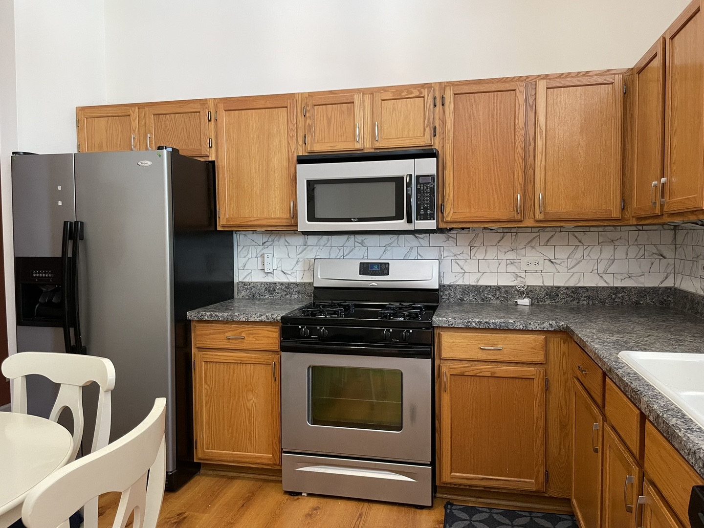 2043 Peach Tree Lane Algonquin, IL 60102 - Photo 8 of 19 a kitchen with granite countertop a stove top oven microwave and refrigerator