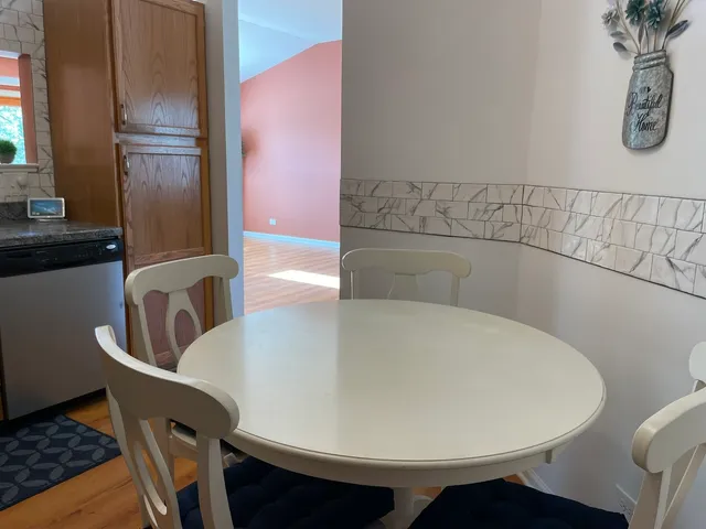 a view of table and chair in wooden floor