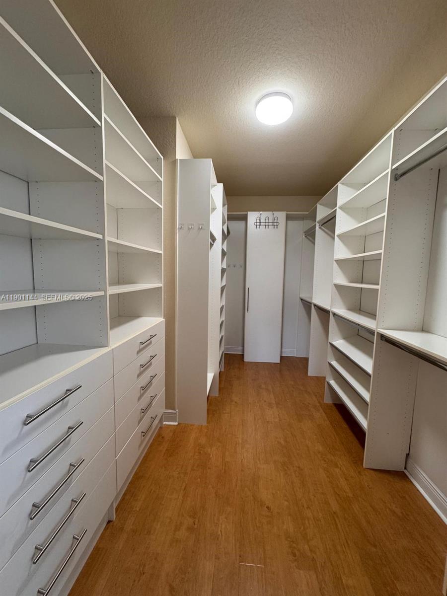 8850 Northwest 98th Court Doral, FL 33178 - Photo 12 of 26 a view of walk in closet with empty racks