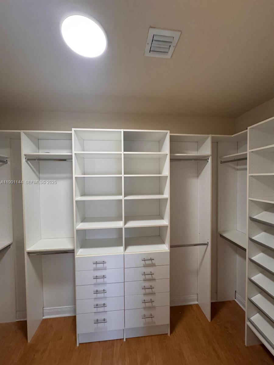 8850 Northwest 98th Court Doral, FL 33178 - Photo 13 of 26 a view of walk in closet with empty racks