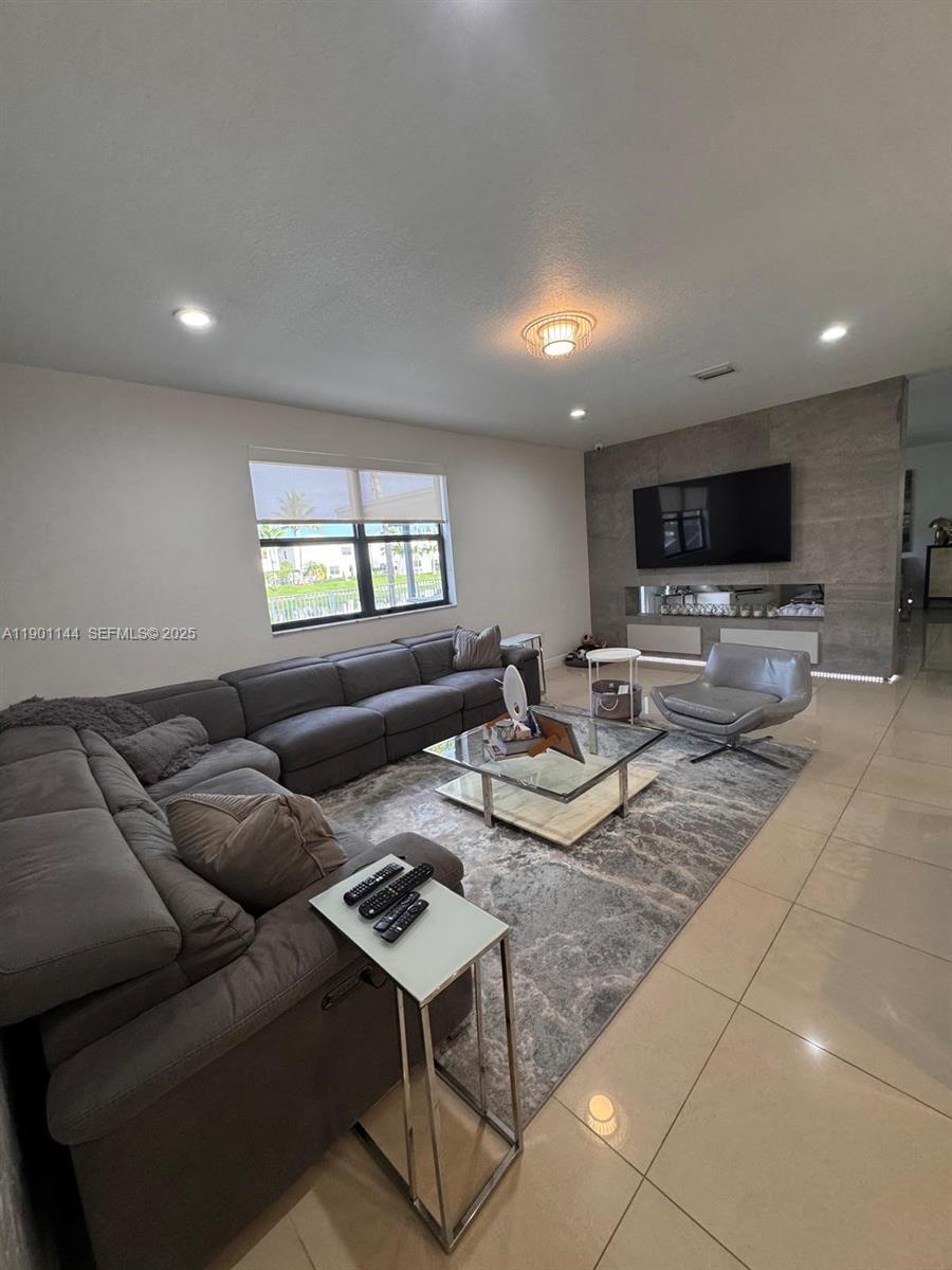 8850 Northwest 98th Court Doral, FL 33178 - Photo 26 of 26 a living room with furniture and a flat screen tv