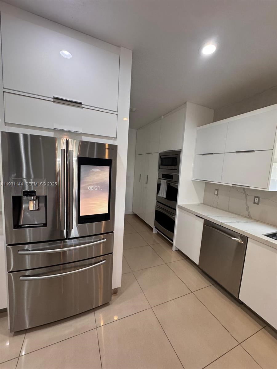 8850 Northwest 98th Court Doral, FL 33178 - Photo 4 of 26 a kitchen with granite countertop a refrigerator and stove