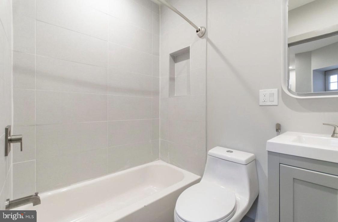 3339 Ridge Avenue Philadelphia, PA 19132 - Photo 14 of 33 a white toilet sitting next to a bathroom sink