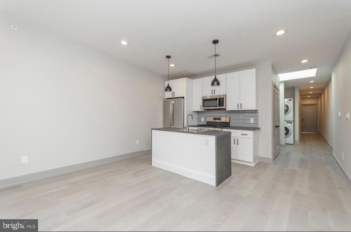 3339 Ridge Avenue Philadelphia, PA 19132 - Photo 5 of 33 a kitchen with granite countertop a sink cabinets stainless steel appliances and a counter top