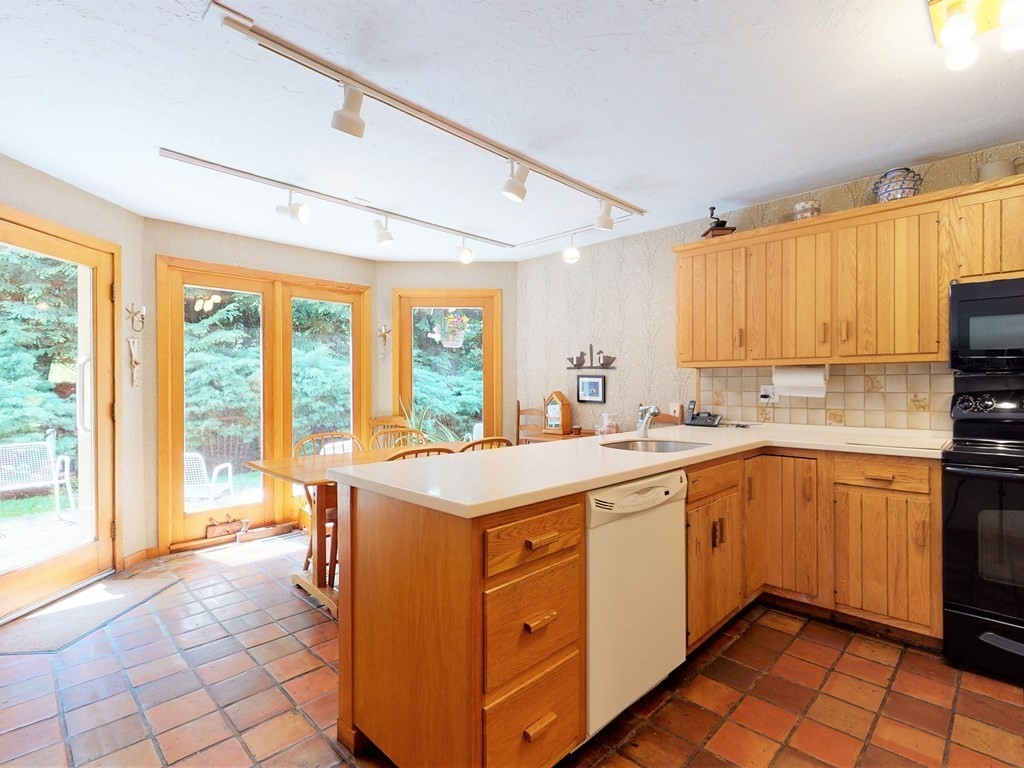 19 Lambert Road Belmont, MA 02478 - Photo 18 of 42 a kitchen with a sink stove and cabinets