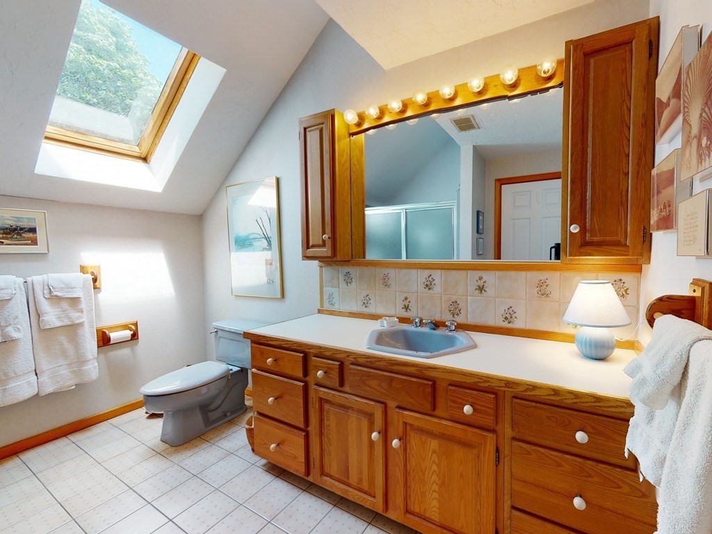 19 Lambert Road Belmont, MA 02478 - Photo 23 of 42 a bathroom with a double vanity sink mirror and toilet