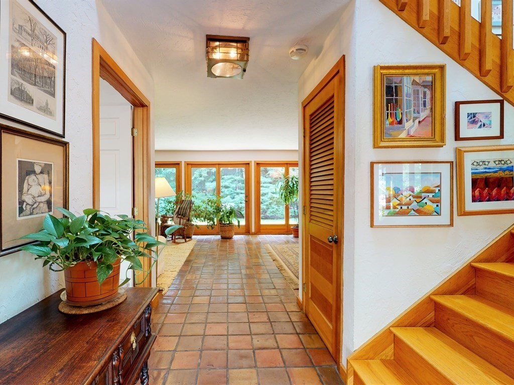 19 Lambert Road Belmont, MA 02478 - Photo 5 of 42 a hallway with a flower pot and wooden floor