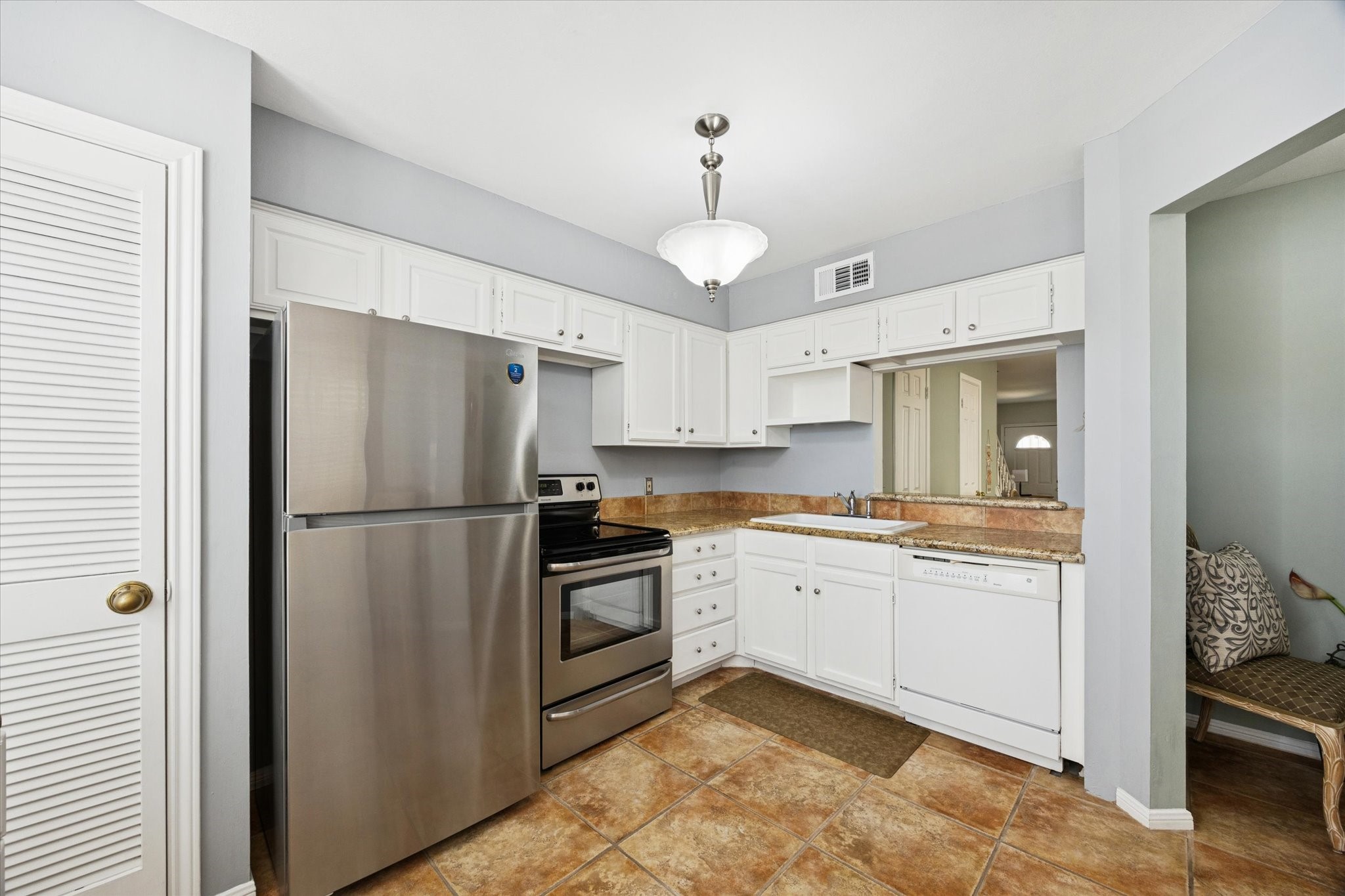 926 Rutland Street Houston, TX 77008 - Photo 5 of 28 This secondary view highlights the kitchen's tidy layout and abundant storage. The open design offers a clear sightline into the living and dining areas, emphasizing the home's connected feel.