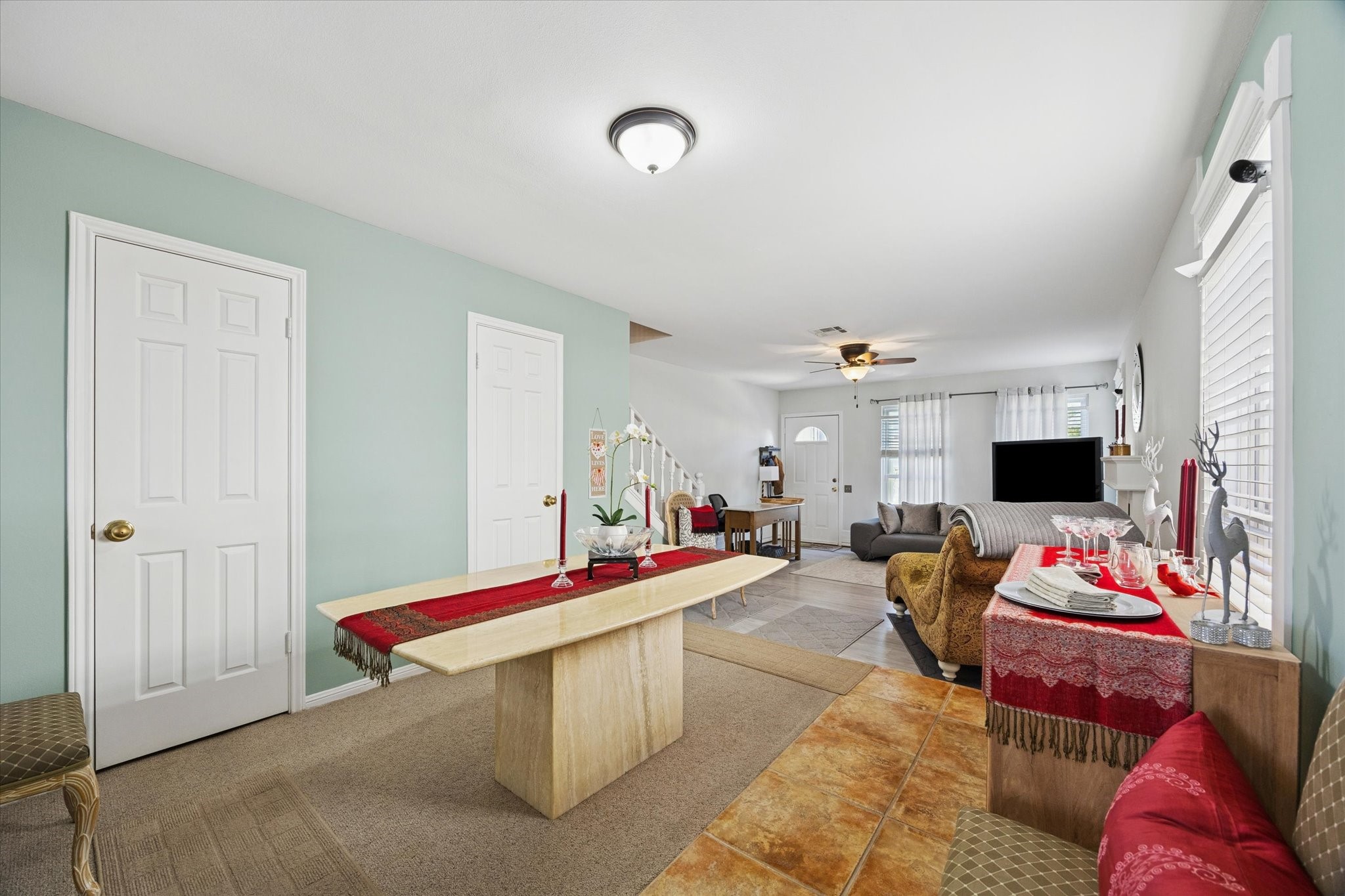 926 Rutland Street Houston, TX 77008 - Photo 7 of 28 The dining area opens to a sunken living room, creating a seamless flow for entertaining. Large windows provide consistent natural light, enhancing the open and airy feel of the transition between levels. Behind the doors is a powder room and closet.