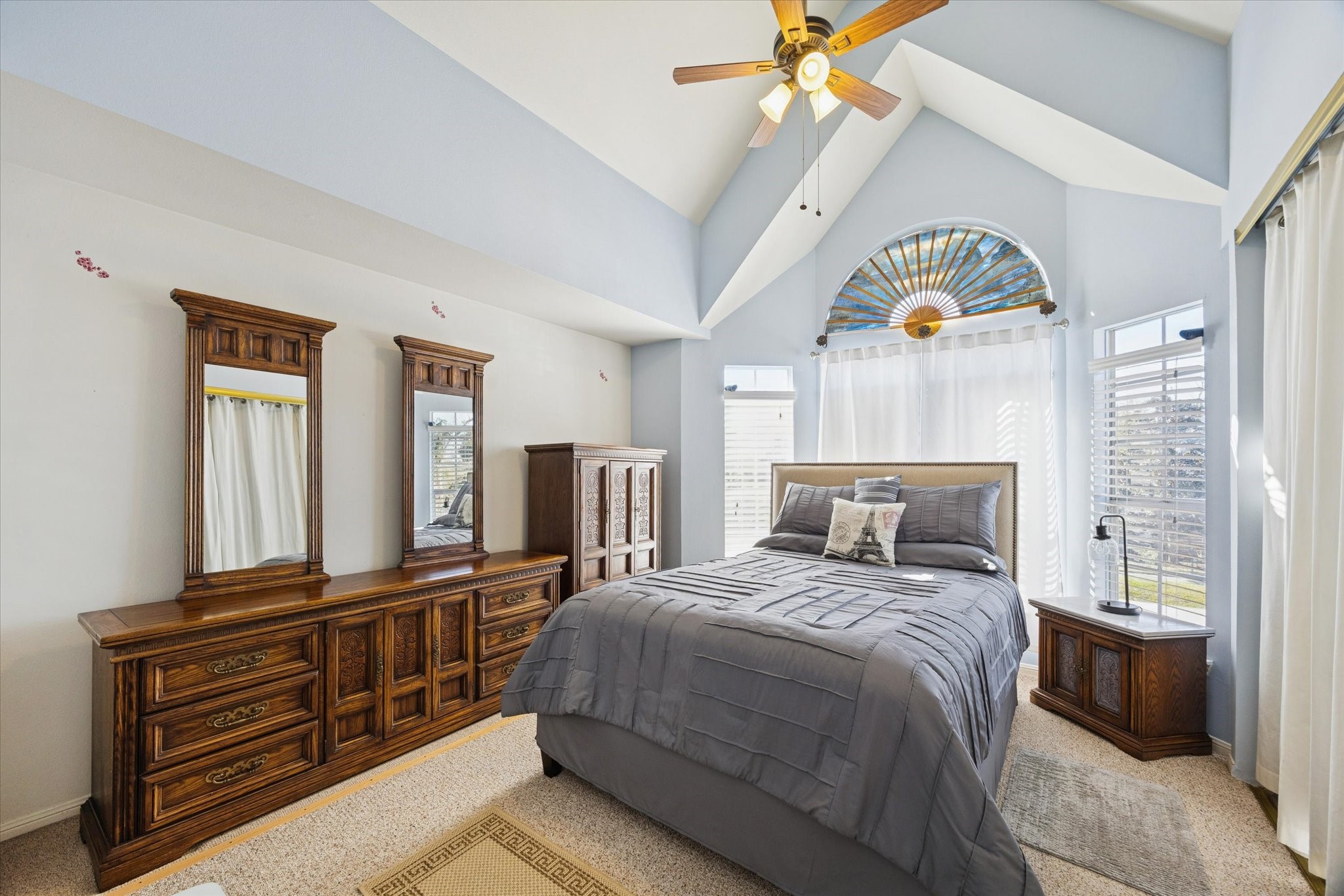 926 Rutland Street Houston, TX 77008 - Photo 10 of 28 The upstairs primary suite features vaulted ceilings and abundant natural light, equipped with installed shades for privacy. This spacious retreat includes durable carpeting and ample closet storage.