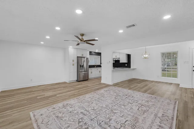 a view of a kitchen with a sink and a refrigerator
