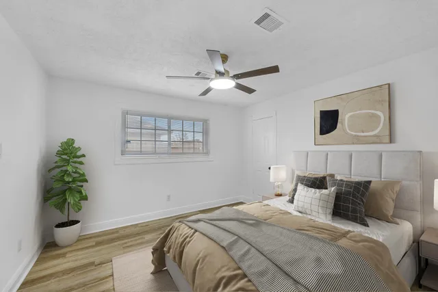 a bedroom with bed and a window