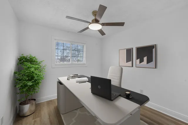 a work room with furniture and potted plant