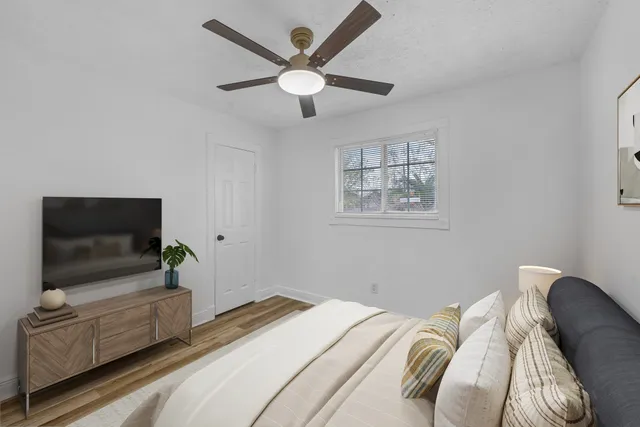 a bedroom with a bed and a flat screen tv