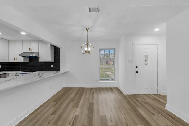 a view of a kitchen with a dishwasher cabinets and wooden floor