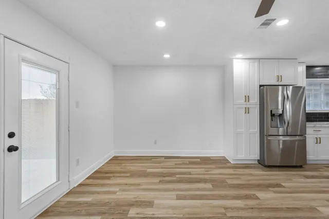 a view of a refrigerator in kitchen and wooden floor