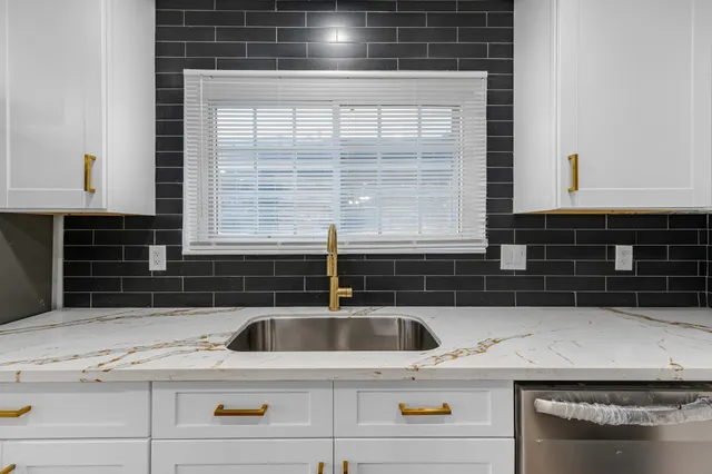 a kitchen with a sink and cabinets