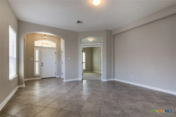 a view of an empty room with glass door