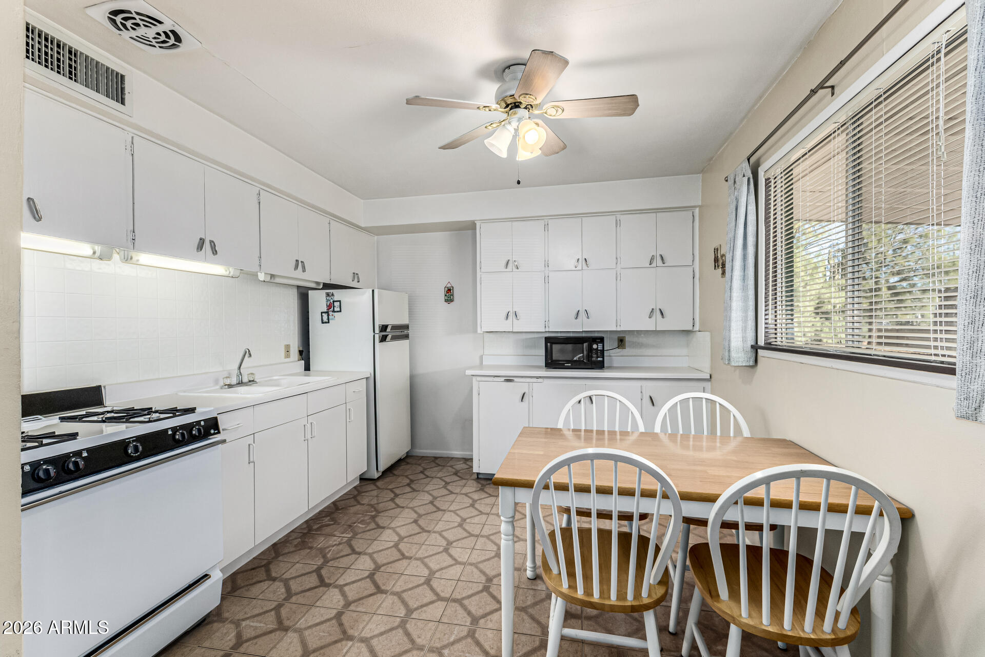700 North Victory Drive Apache Junction, AZ 85120 - Photo 11 of 28 a kitchen that has a stove and a white cabinets