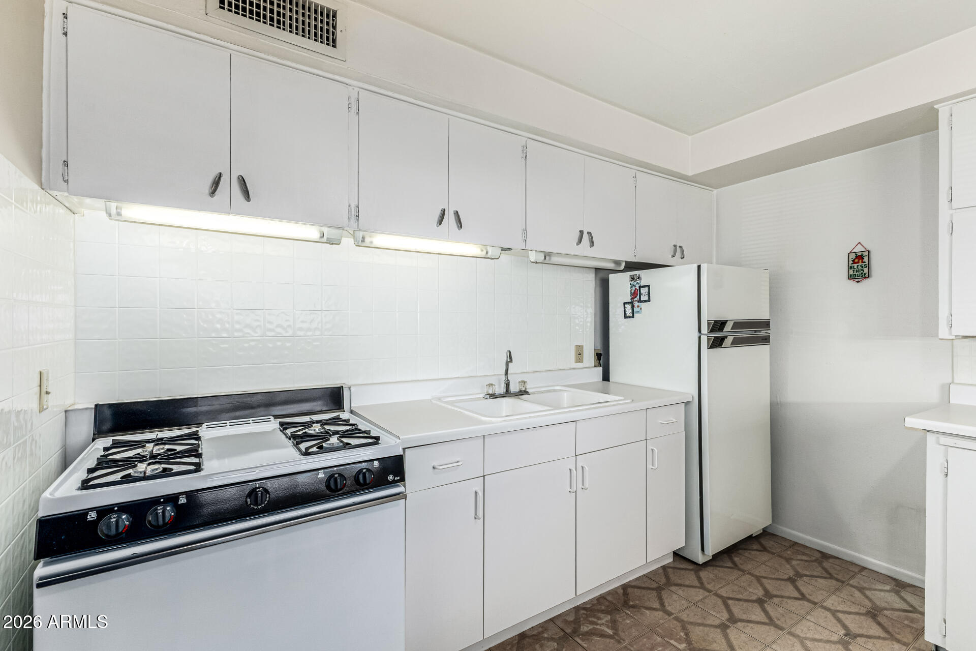 700 North Victory Drive Apache Junction, AZ 85120 - Photo 12 of 28 a kitchen with stainless steel appliances a stove a refrigerator and a sink