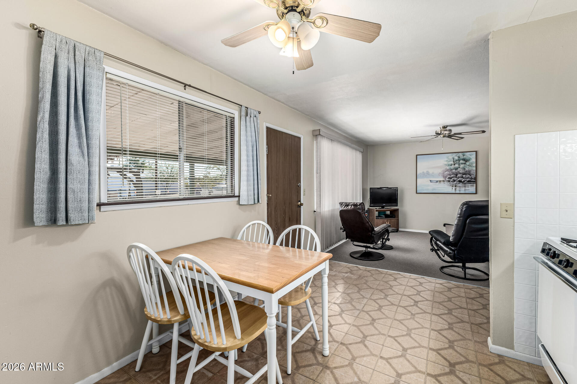 700 North Victory Drive Apache Junction, AZ 85120 - Photo 13 of 28 a living room with furniture a chandelier and a window