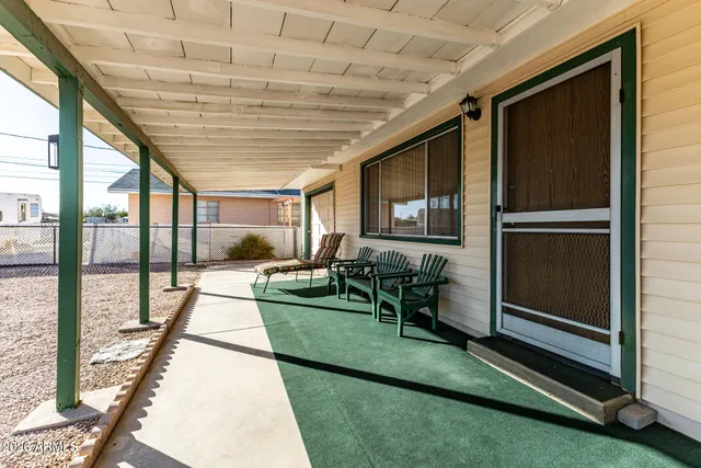 a backyard of a house with outdoor seating