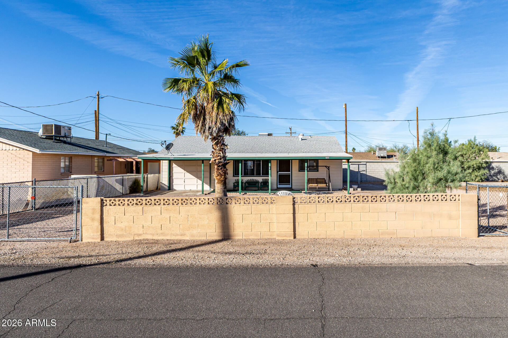 700 North Victory Drive Apache Junction, AZ 85120 - Photo 3 of 28 a front view of a house with a yard and garage