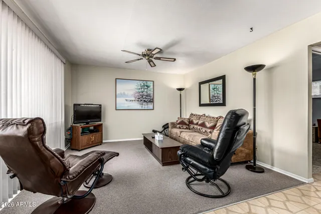 a living room with furniture gym equipment and a window