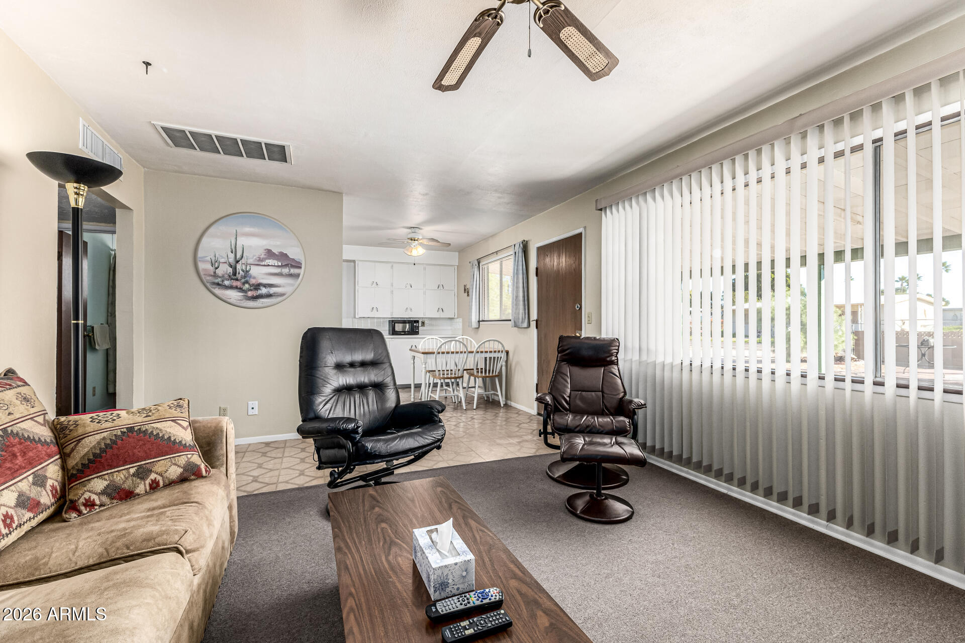 700 North Victory Drive Apache Junction, AZ 85120 - Photo 10 of 28 a view of a livingroom with furniture a ceiling fan and a window
