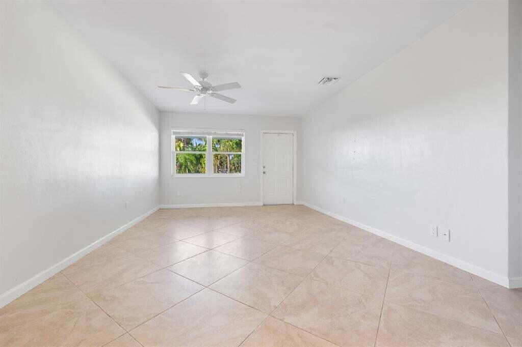 3801 Northeast 22nd Terrace, Unit 2 Lighthouse Point, FL 33064 - Photo 7 of 19 an empty room with windows and ceiling fan