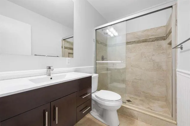 an empty room with a window and ceiling fan