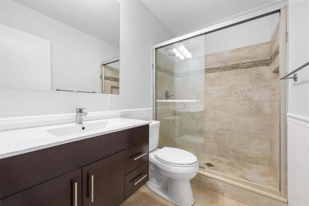 3801 Northeast 22nd Terrace, Unit 2 Lighthouse Point, FL 33064 - Photo 8 of 19 a bathroom with a sink and a mirror