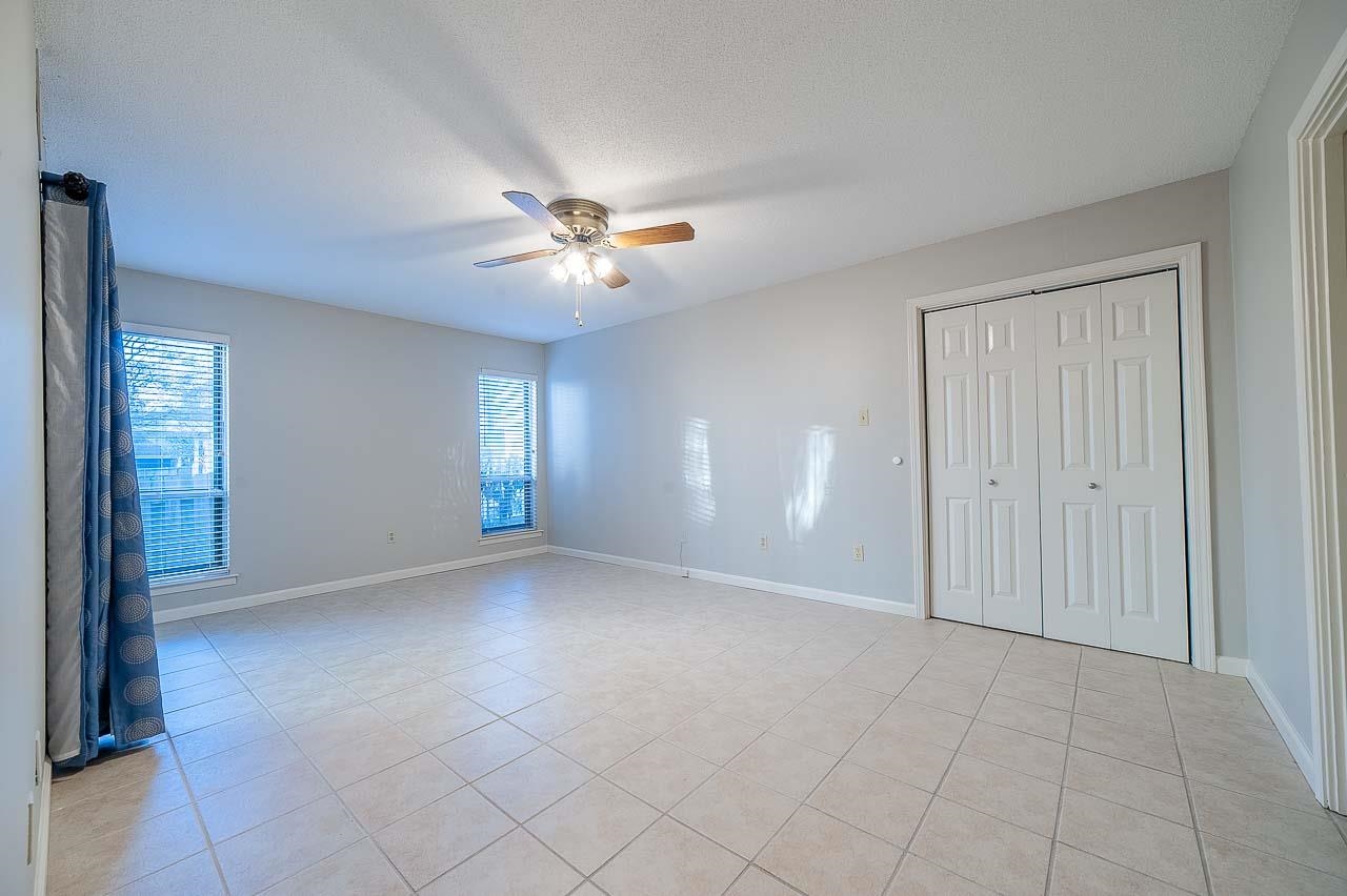409 South Perkins Road, Unit 3 Memphis, TN 38117 - Photo 14 of 23 Primary bedroom has doors to the back patio, walk in closet plus another closet plus storage in the private bathroom.