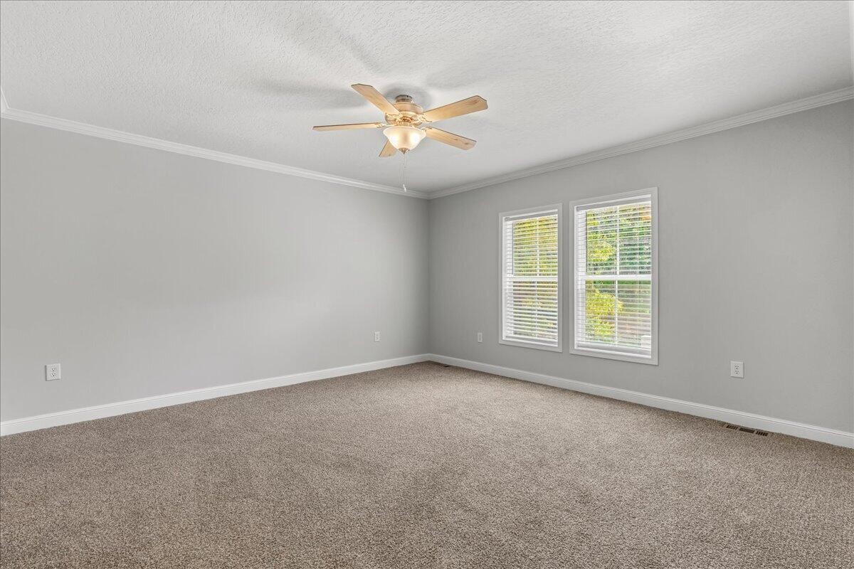 1629 Wasson Road Ten Mile, TN 37880 - Photo 22 of 27 an empty room with windows and fan